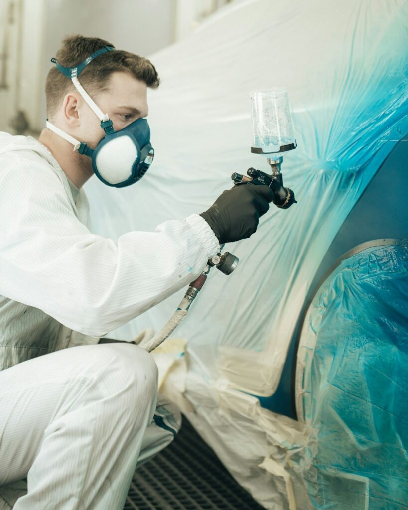 commercial painter using pneumatic paint sprayer